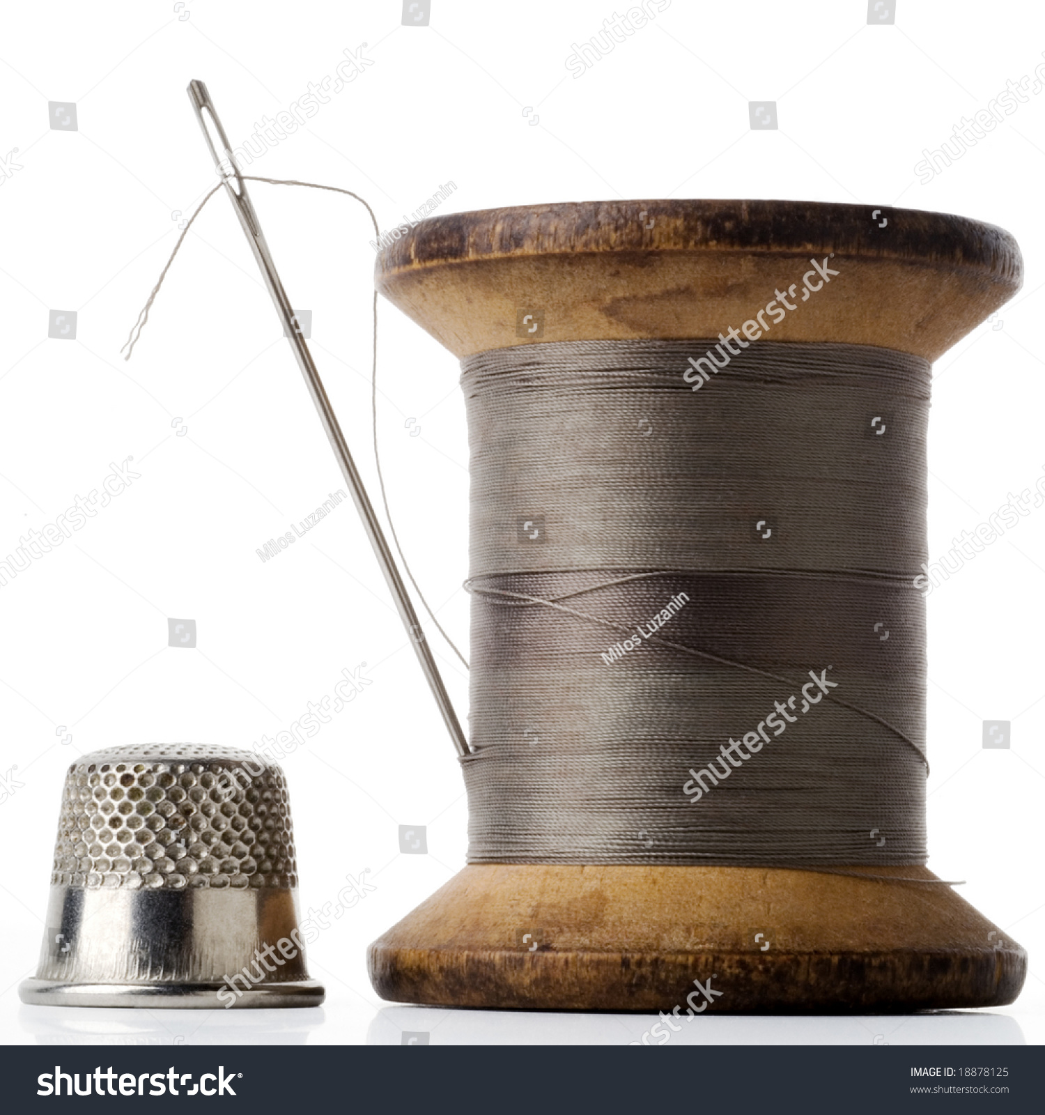 Spool Of Thread With Needle Stuck In And Thimble On White Stock Photo ...