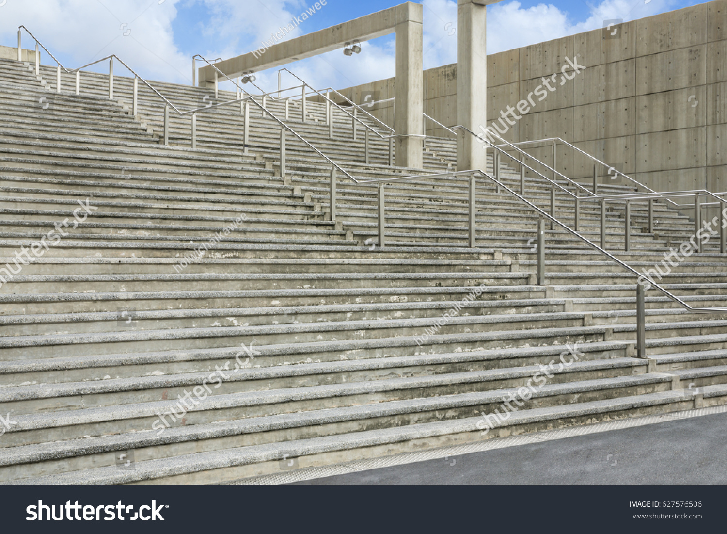 stock-photo-stadium-concrete-stairs-with-clouds-and-blue-sky-627576506.jpg