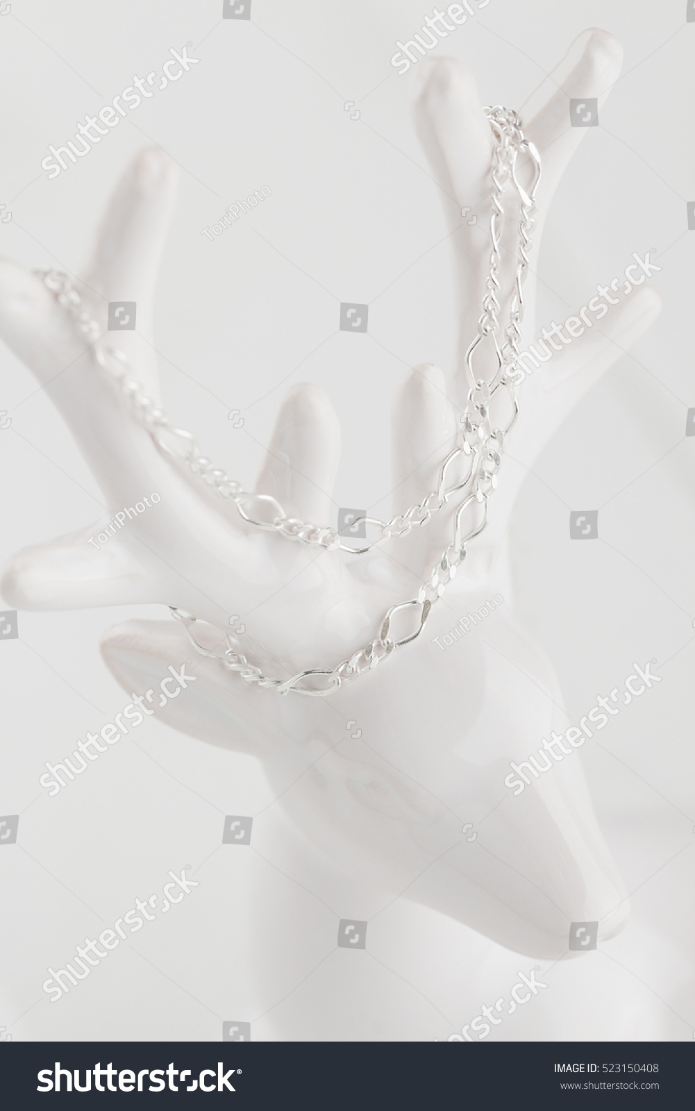https://www.shutterstock.com/pic-523150408/stock-photo-sterling-silver-chain-on-white-jewelry-holder-still-life.html