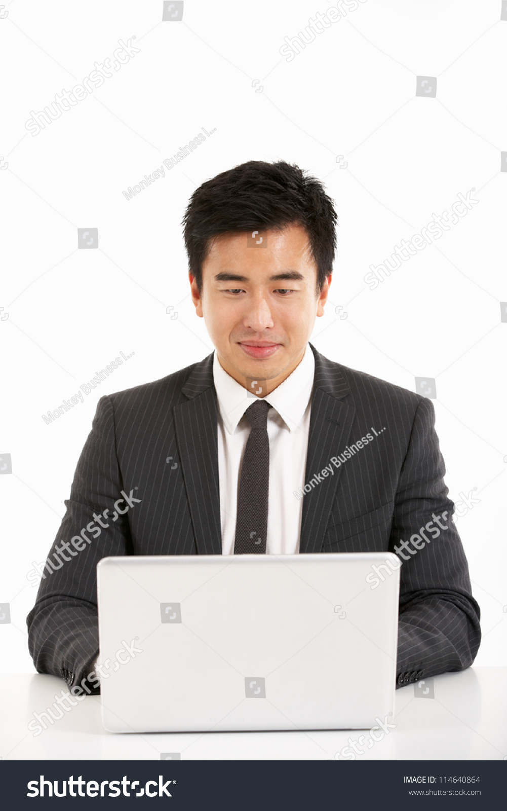 Studio Shot Of Chinese Businessman Working On Laptop Stock Photo ...