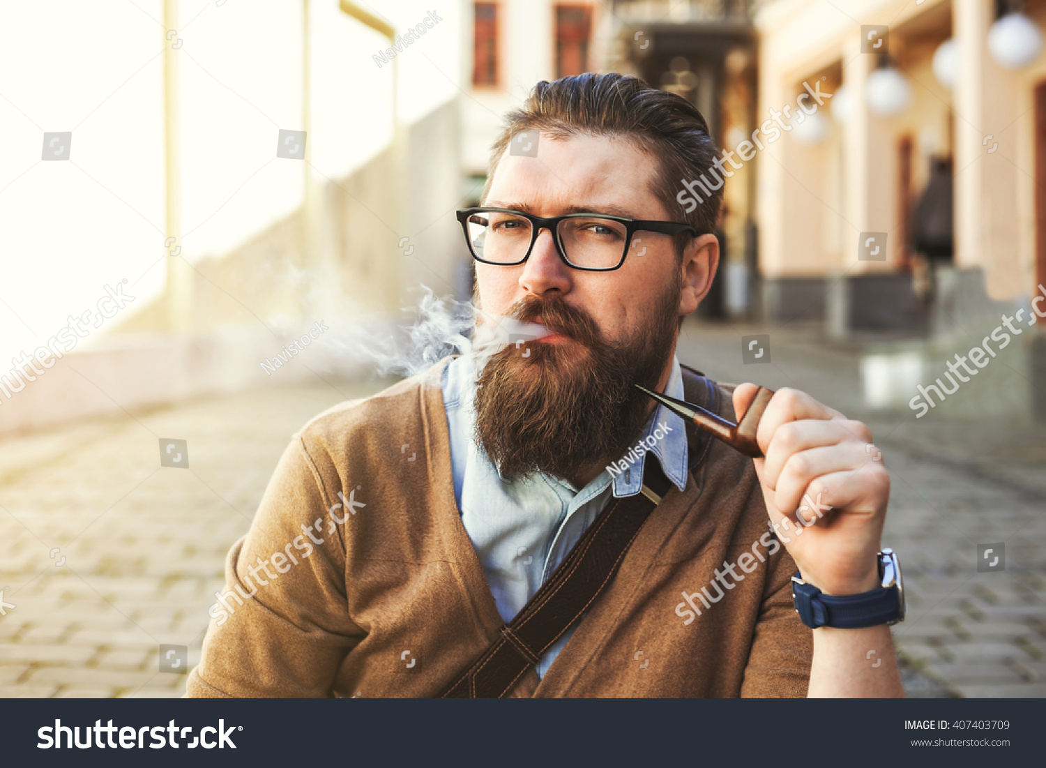 stock-photo-stylish-hipster-bearded-man-in-the-street-bike-leather-handbag-glasses-smoking-pipe-vintage-407403709.jpg