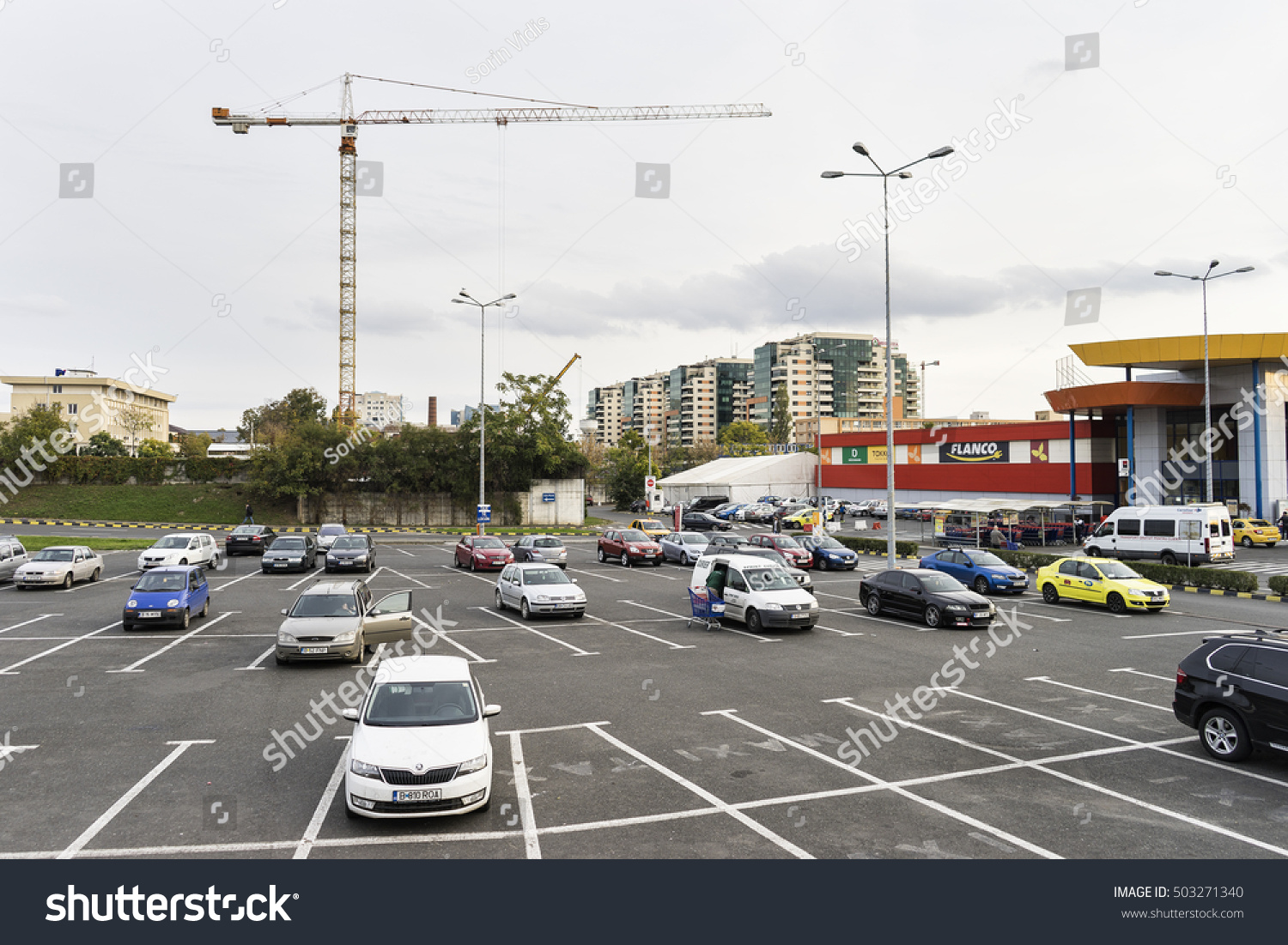 Supermarket Parkingview Of A Supermarket Parking Lot With Cranes In