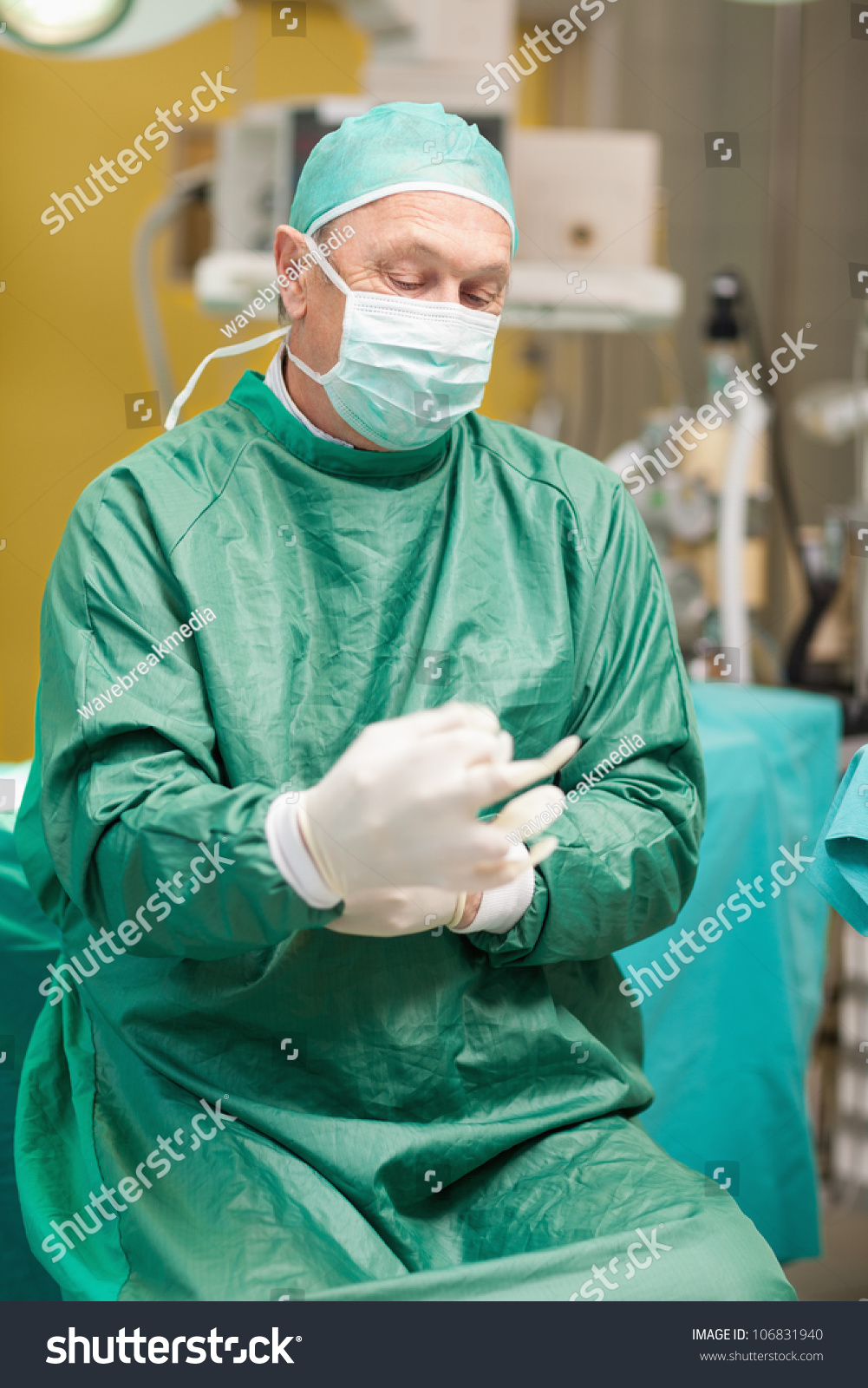 Surgeon Putting On Surgical Gloves In A Surgical Room Stock Photo ...