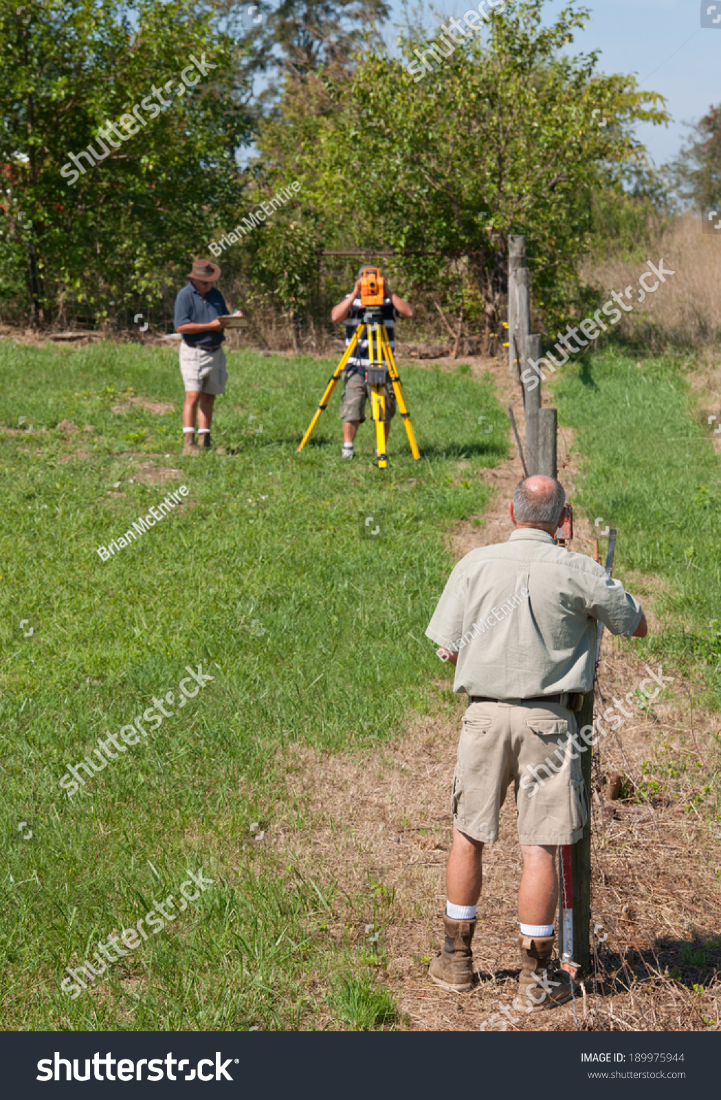 Survey Crew Working Outside With Tripod, Electronic Distance Meter, And ...