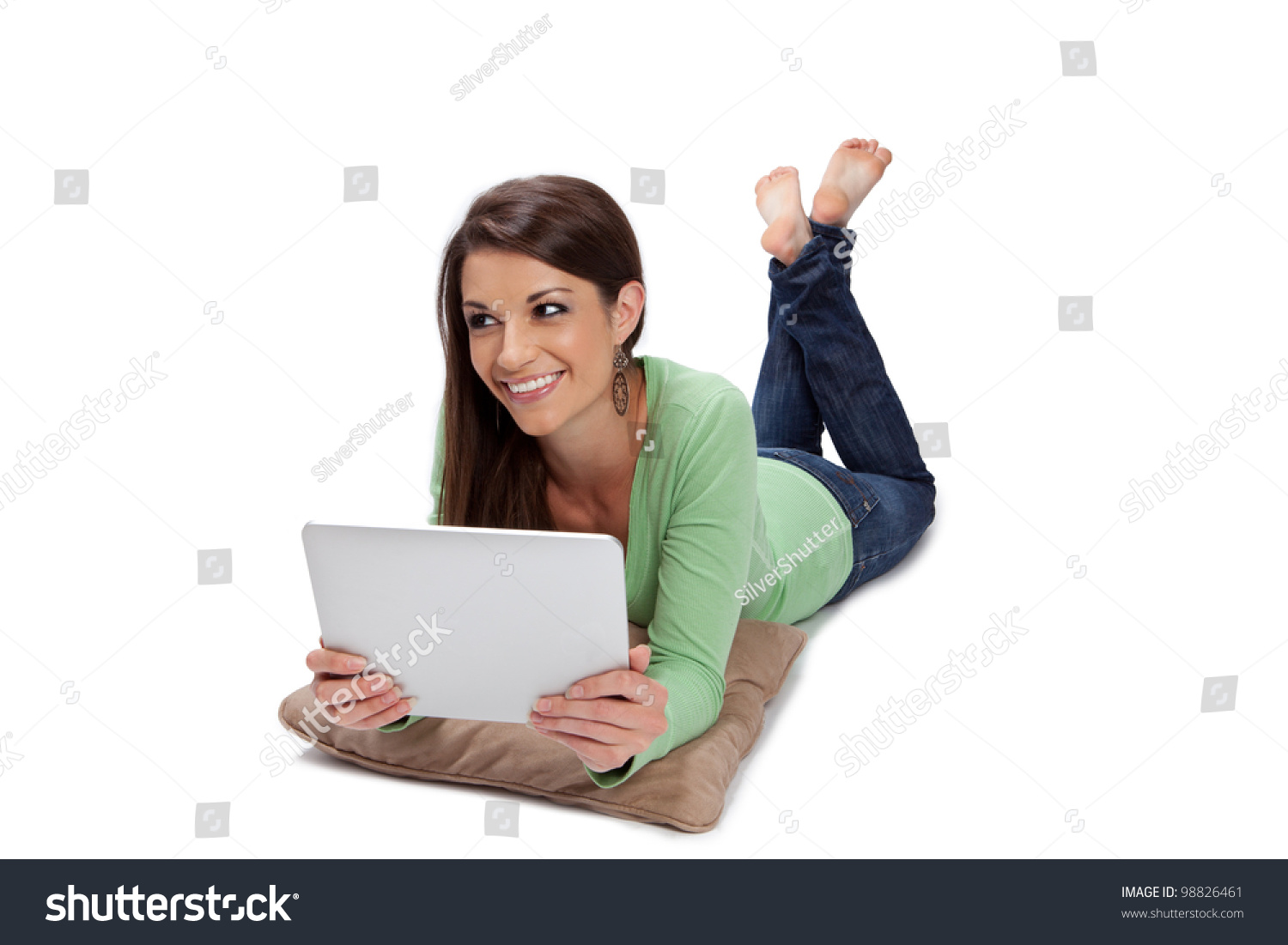 Tan Girl Laying On Stomach Is Enjoying Her Tablet Computer. Stock Photo ...