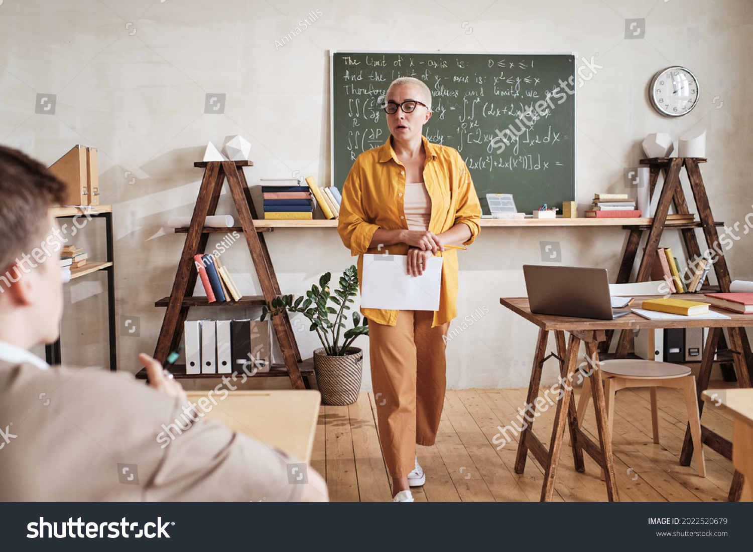 Teacher Walking Through Classroom Explaining Materialto Stock Photo ...