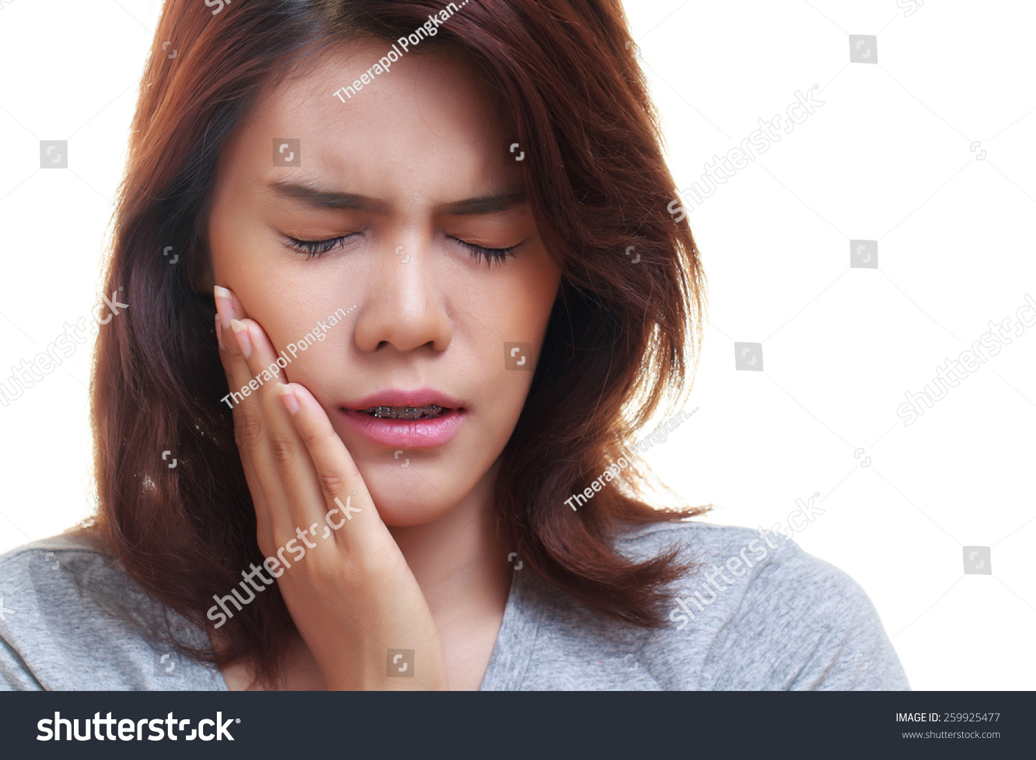 Teen Woman Pressing Her Bruised Cheek With A Painful Expression As If Shes Having A Terrible Teen Woman Pressing Her Bruised Cheek With A Painful Expression As If Shes Having A Terrible