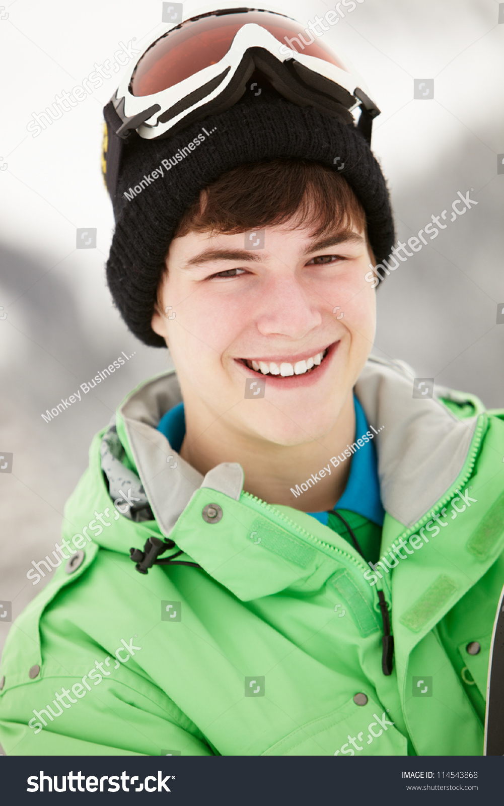 Teenage Boy With Snowboard On Ski Holiday In Mountains Stock Photo ...