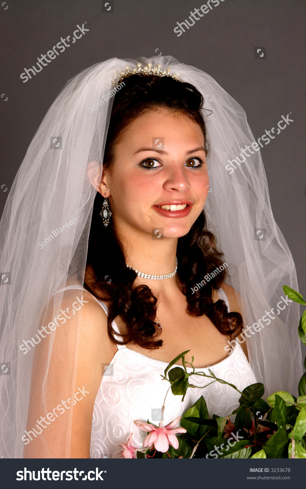 Teenage Bride In Wedding Dress And Veil And Wearing Rhinestone Necklace ...