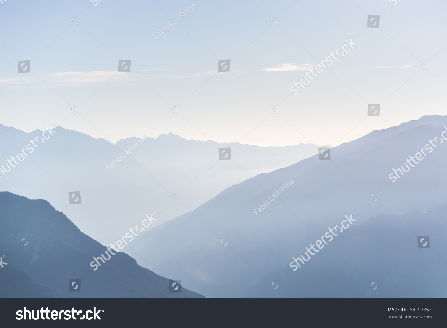 Telephoto View Of Distant Blue Toned Mountain Range At Sunrise With ...