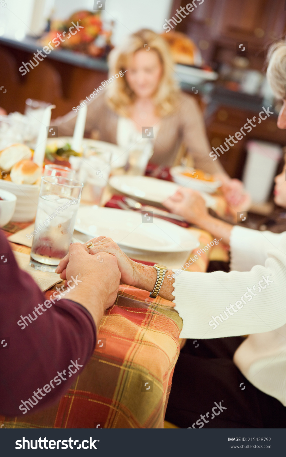 Thanksgiving Family Praying Before Holiday Dinner Stock Photo