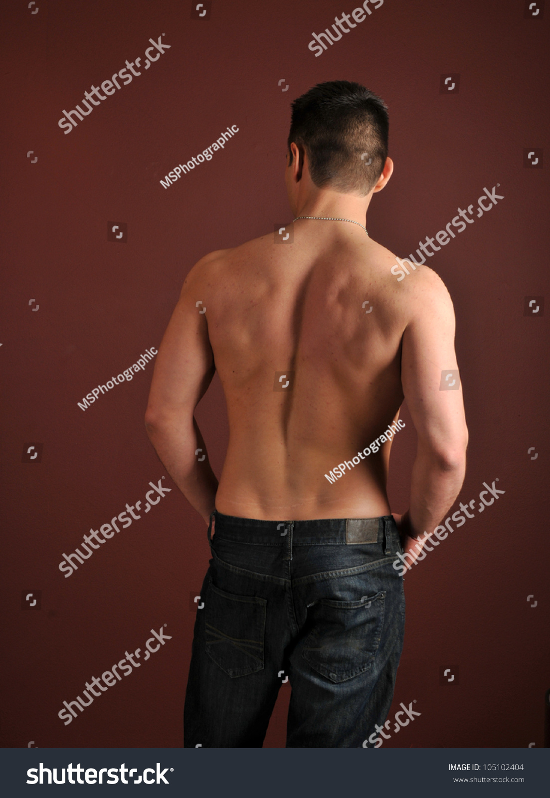 The Back Of A Shirtless Muscular Man In Blue Jeans Stock Photo ...