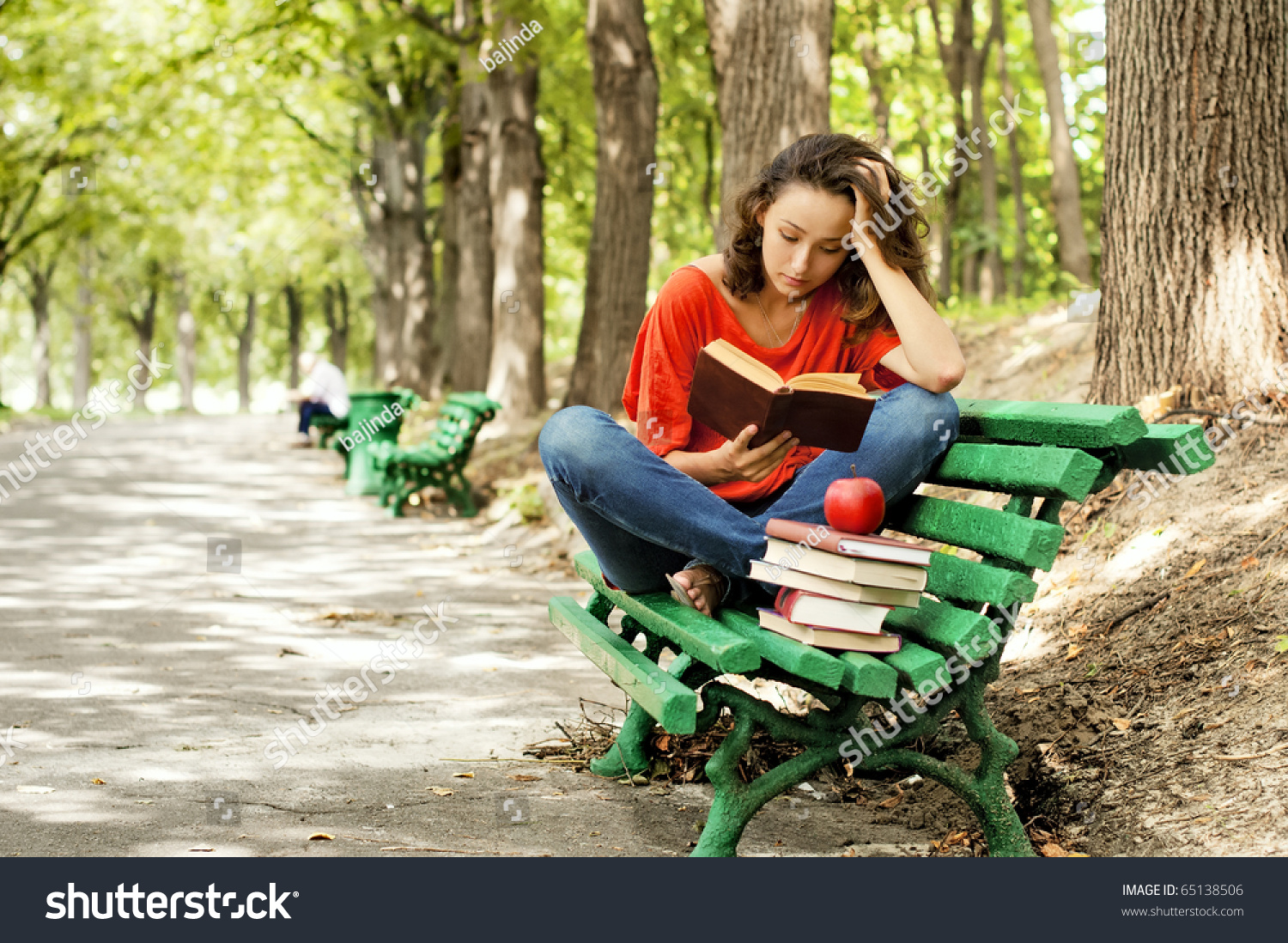 The Girl Sitting On A Bench, Reading A Book Stock Photo 65138506 ...