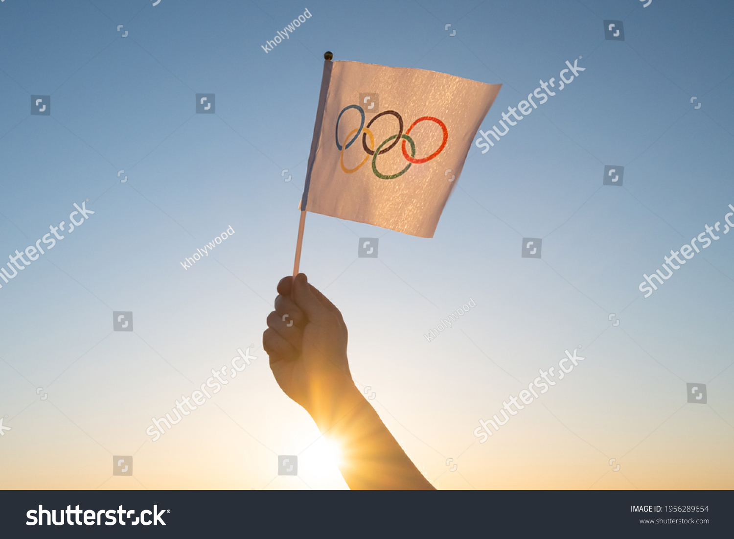 219 2024 Summer Olympics Images Stock Photos Vectors Shutterstock   Stock Photo The Olympic Flag Small In Hand Flutters Against The Backdrop Of Blue Sky And Setting Sun Concept 1956289654 