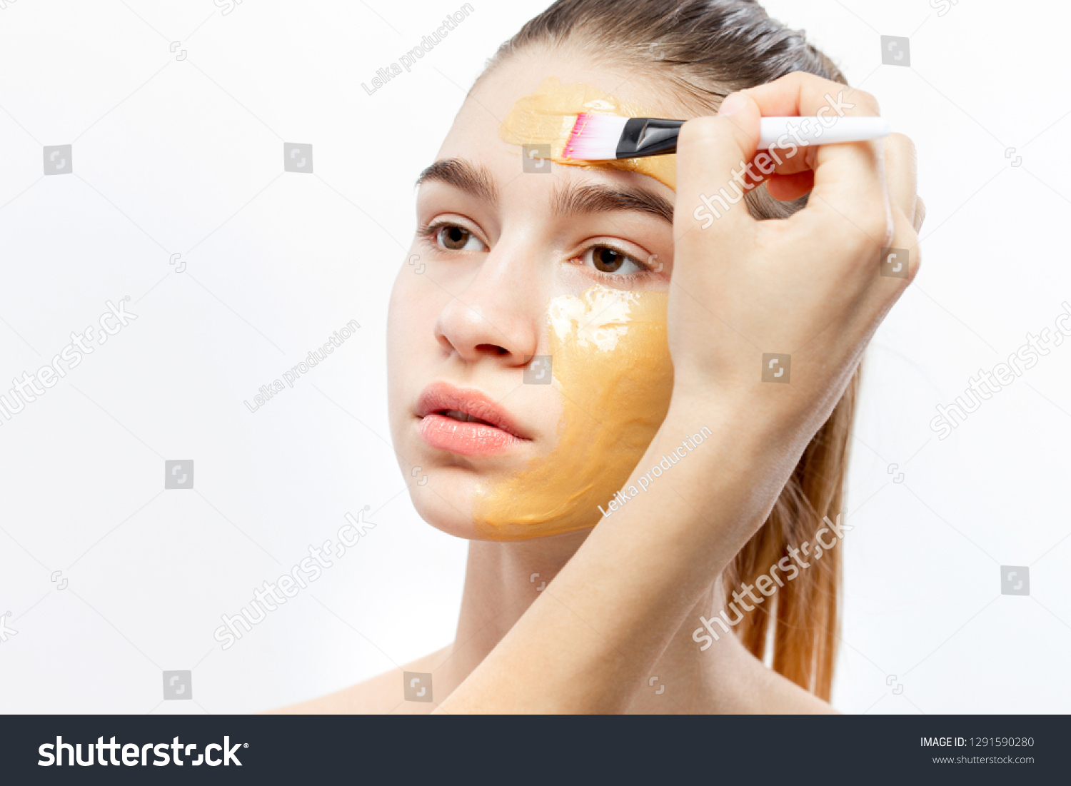 Download Process Applying Yellow Cosmetic Mask Brush People Stock Image 1291590280 PSD Mockup Templates