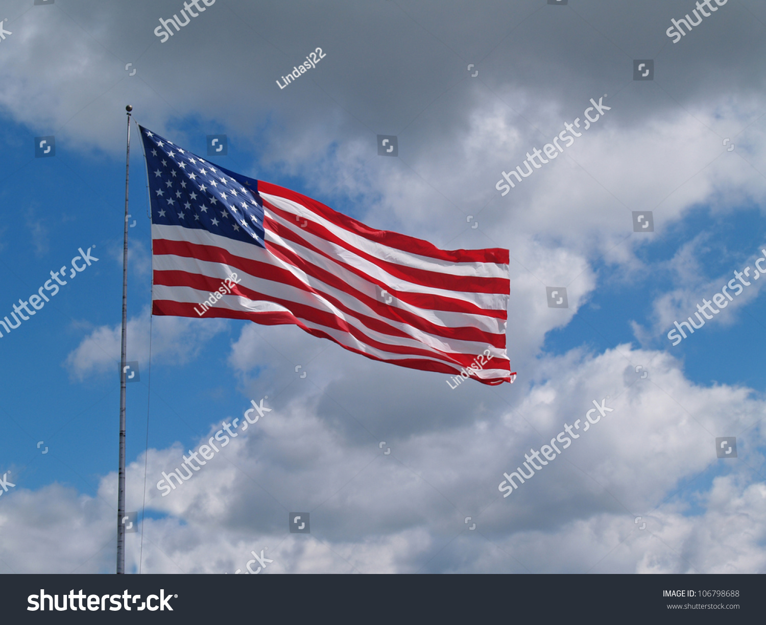 The Us American Red, White And Blue Flag Flying In Front Of A Blue ...