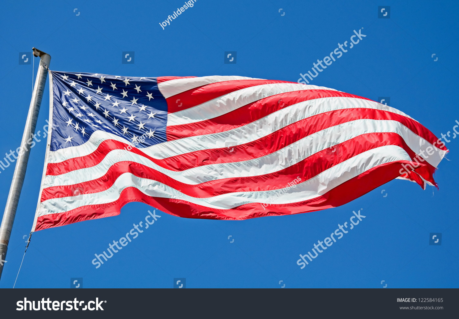 This American Flag Is Flying In A Bright Blue, Clear Sky In This ...