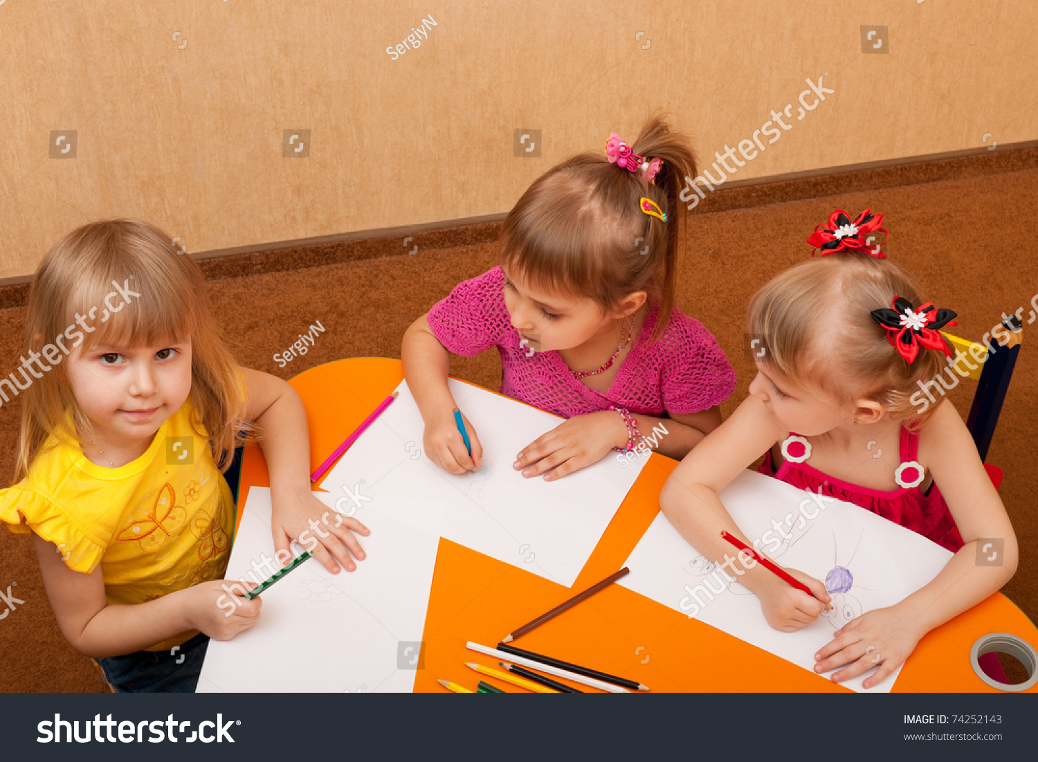 Three Little Girls Casual Sitting Around Stock Photo Edit Now