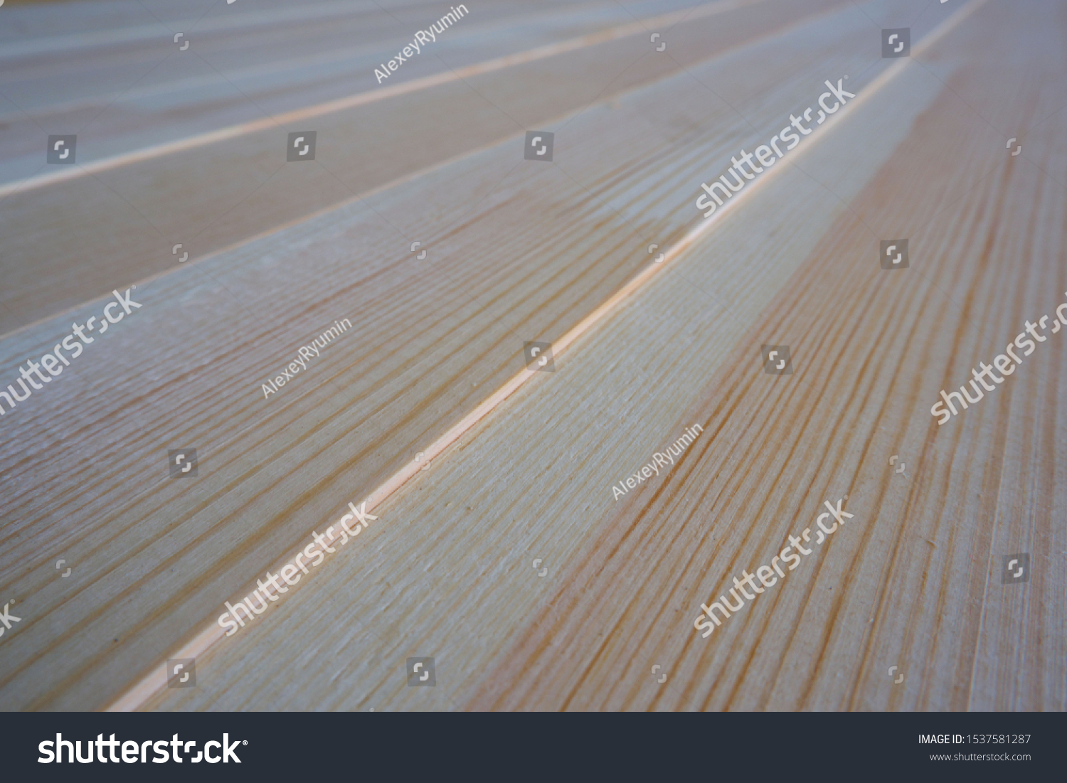 Top close up view of stack of three-layer wooden glued laminated timber beams from pine finger joint spliced boards for wooden windows, selective focus