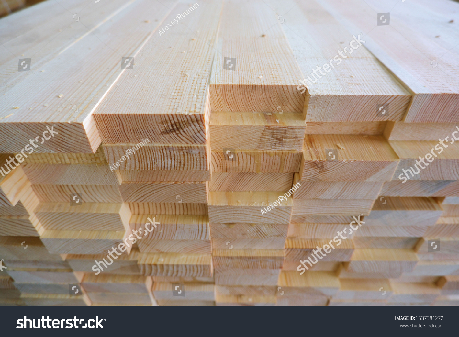 Top-end view of stack of three-layer wooden glued laminated timber beams from pine finger joint spliced boards for wooden windows