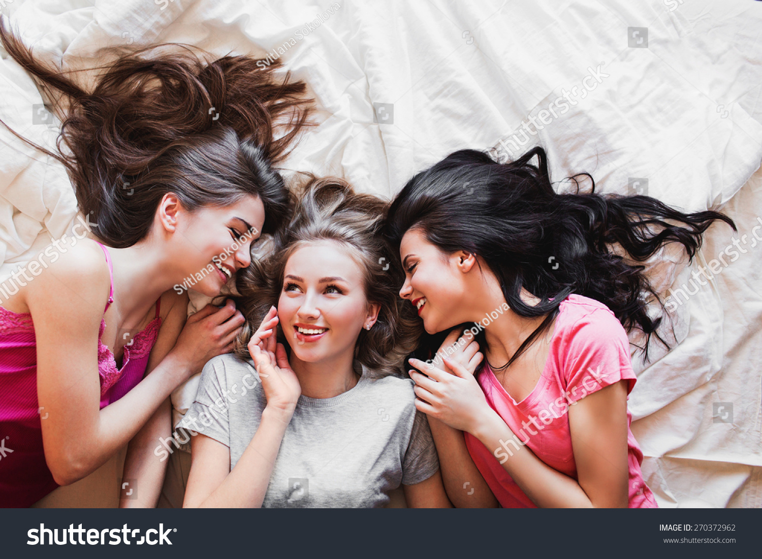 Top View Of Three Best Friends Tell Secrets In Bed . Group Of Pretty ...