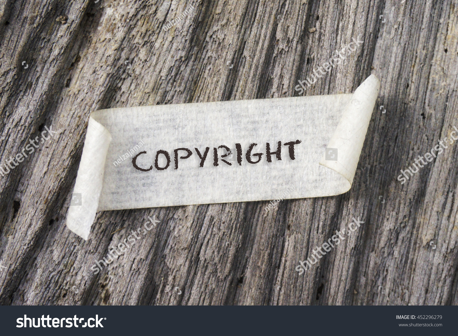 TORN Paper With COPYRIGHT Word On Wooden Background GRAIN AND RUSTIC EFFECT TORN Paper With COPYRIGHT Word On Wooden Background GRAIN AND RUSTIC EFFECT