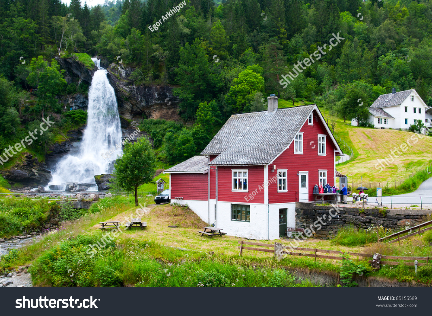 Traditional Norwegian Red Wooden House With Waterfall In The Distance ...