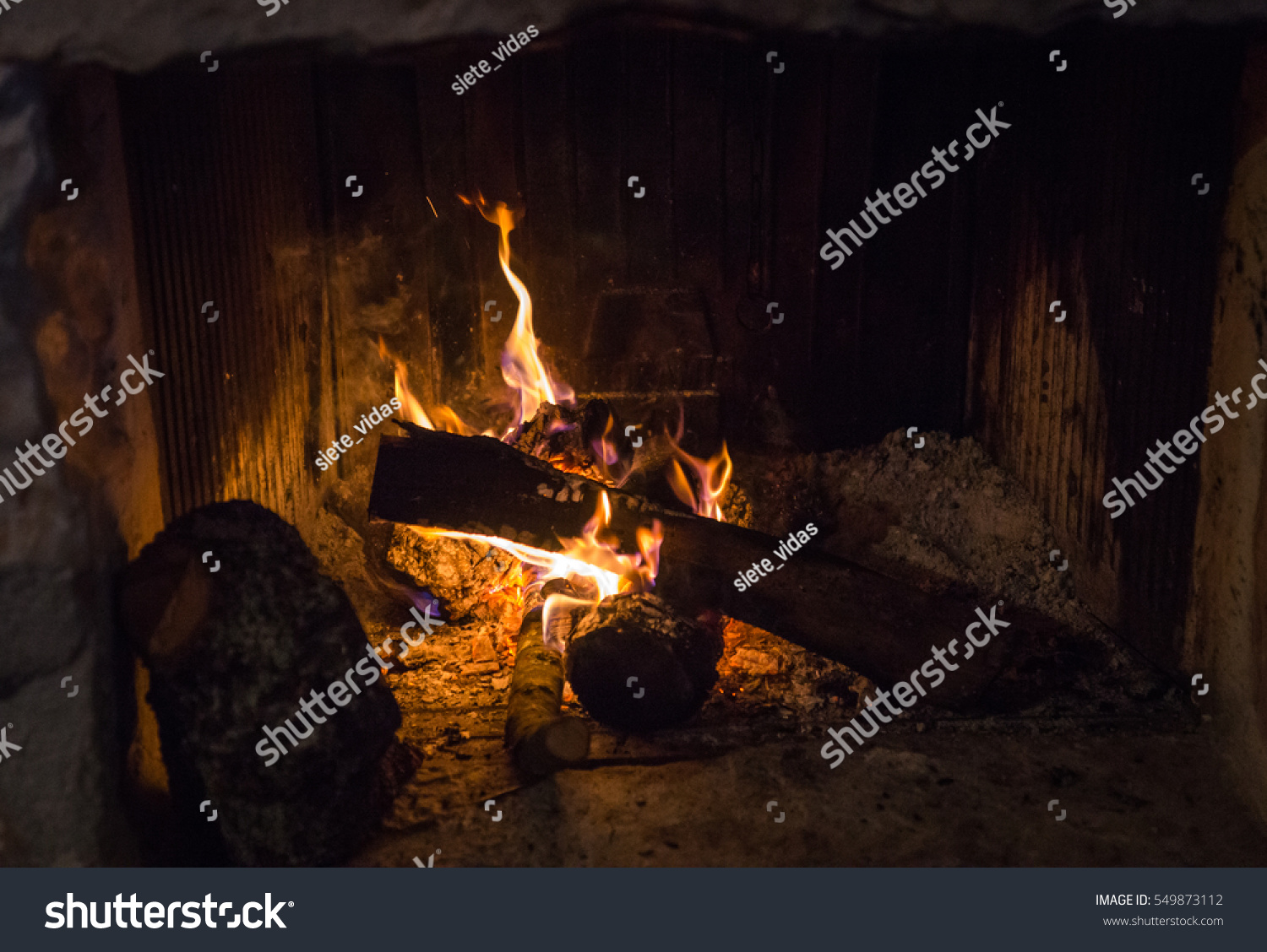 Traditional Stonemade Fireplace Burning Wood Mani Stock Photo