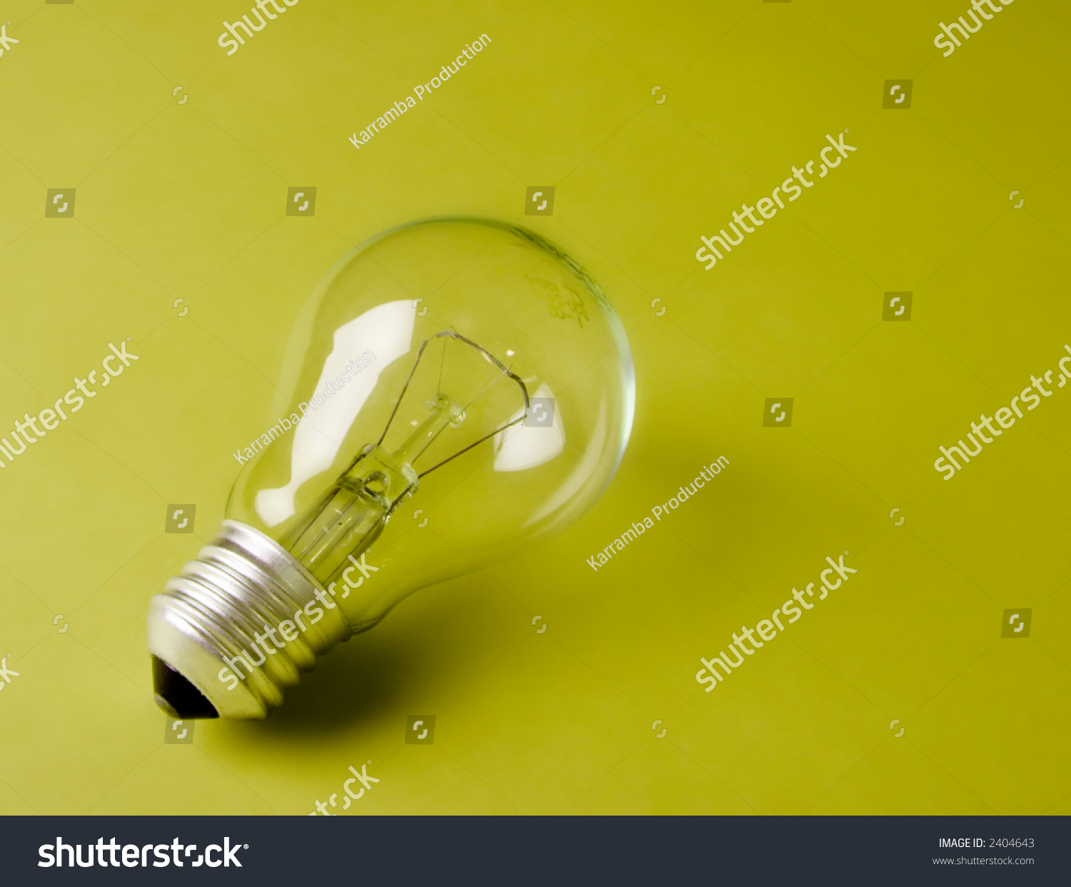 Transparent Light Bulb Laying On The Geen Background Stock Photo ...