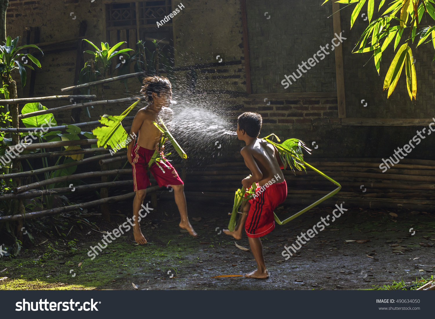 Two Boys Playing Traditional Water Splash Stock Photo 490634050