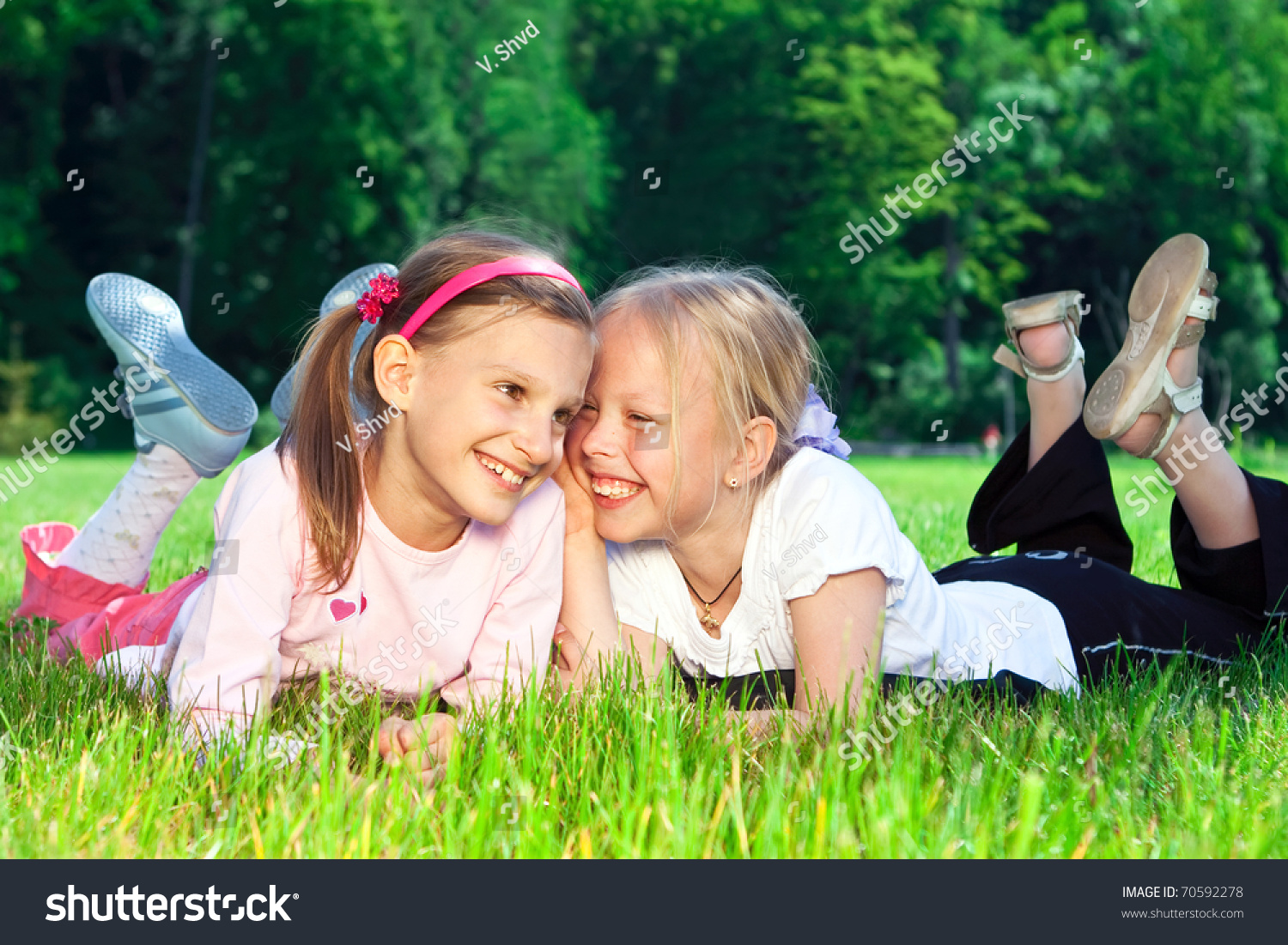 Two Cute Girls Laughing On The Green Grass Stock Photo 70592278 ...