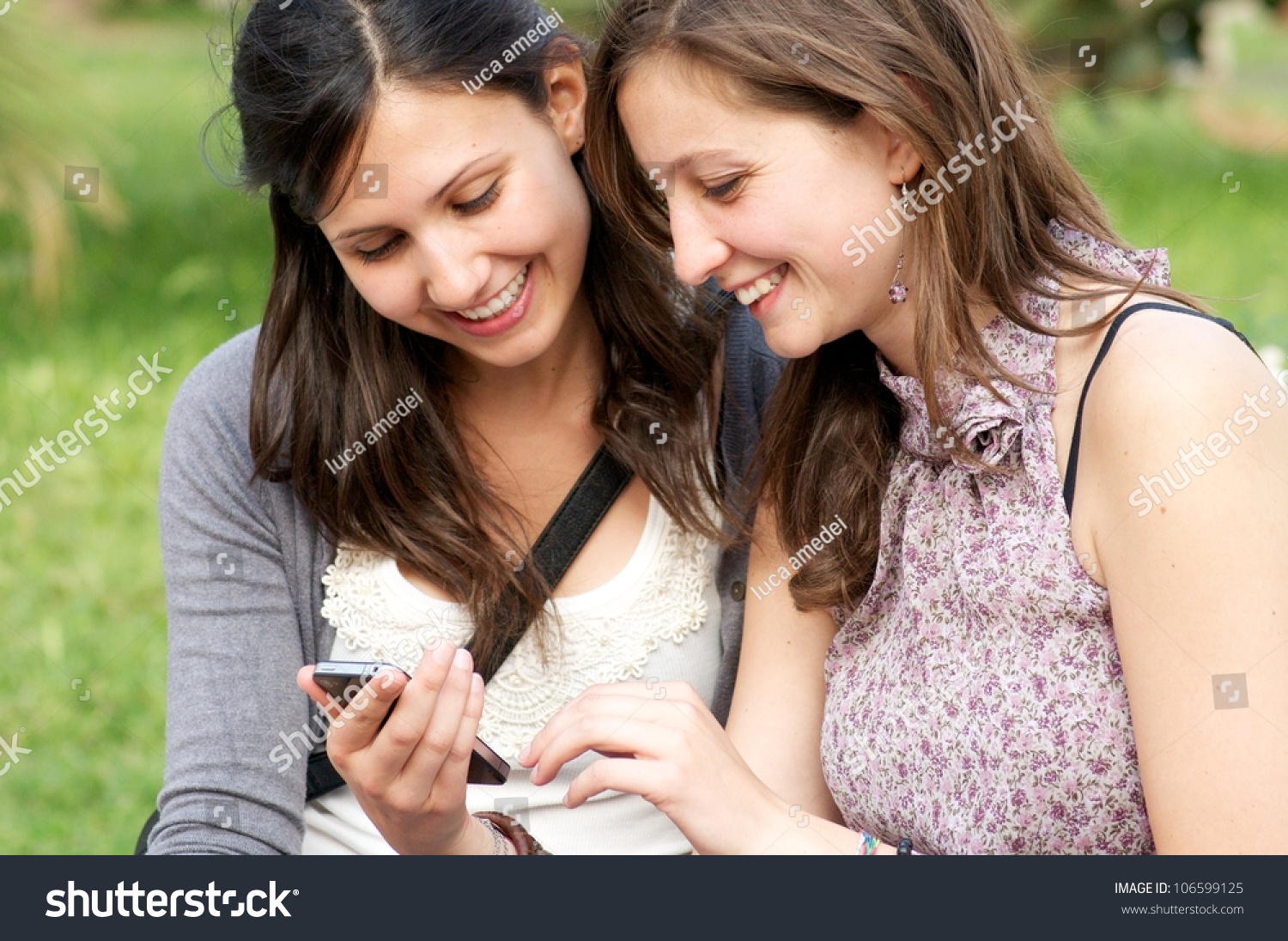 Two Girl While They Make A Speak A Phone Stock Photo 106599125 ...