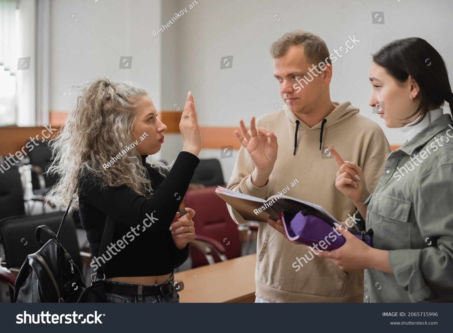 Two girls and a guy talking in sign language