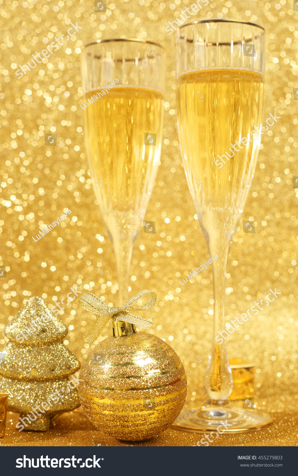 Two Glasses Of Champagne With Golden Glitter Lights On Background Stock ...