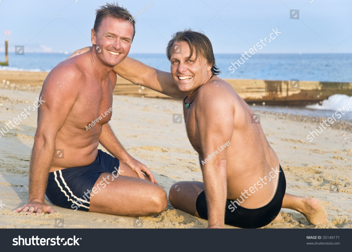 Two Handsome Mature Gay Men Having Fun On Beach