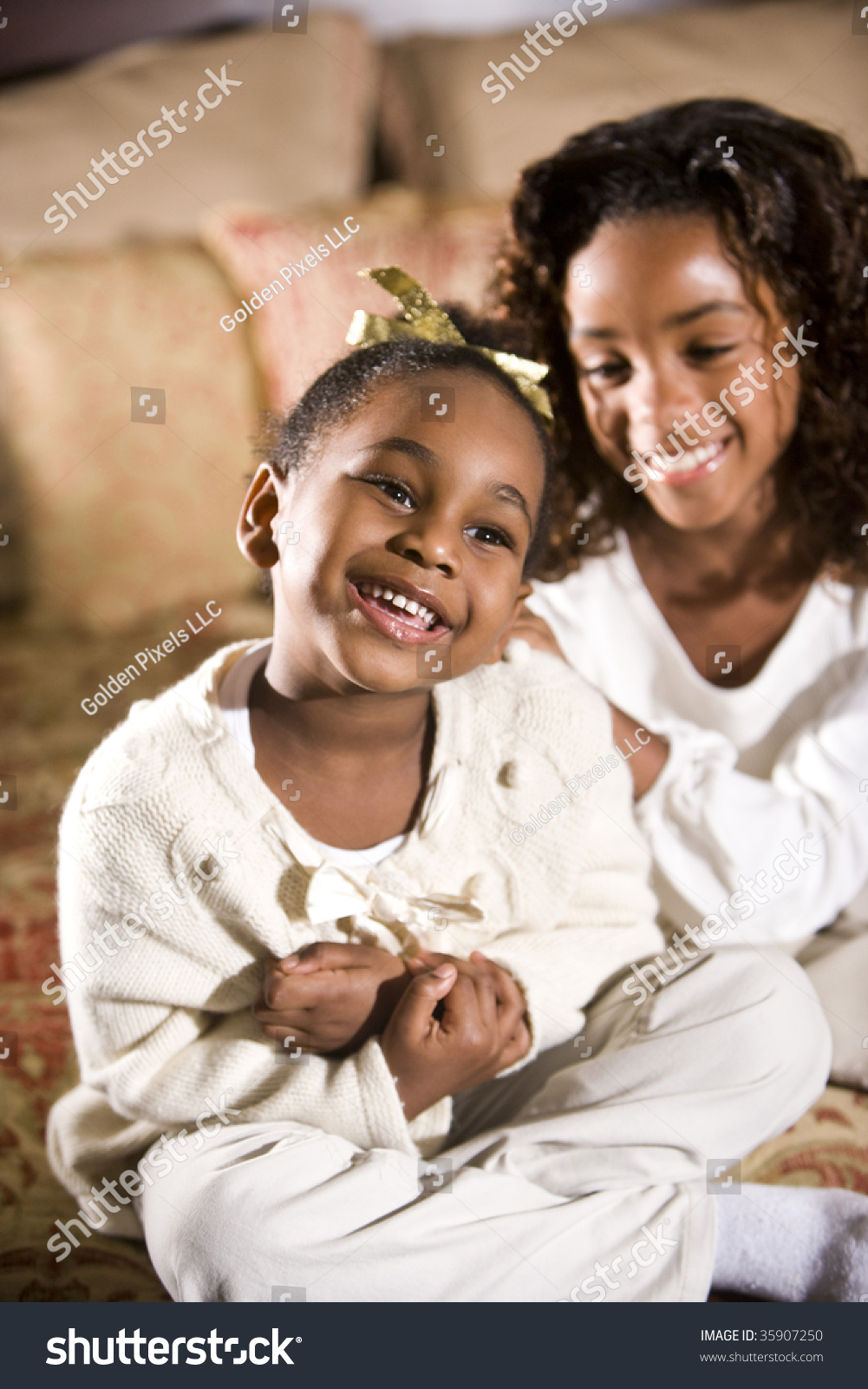 Two Happy African American Sisters Sitting Together In Bedroom Stock ...