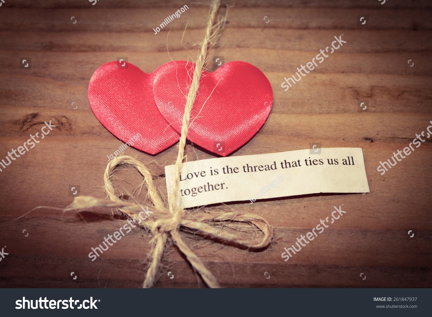 Two hearts tied to her with the quote Love is the thread that ties us all
