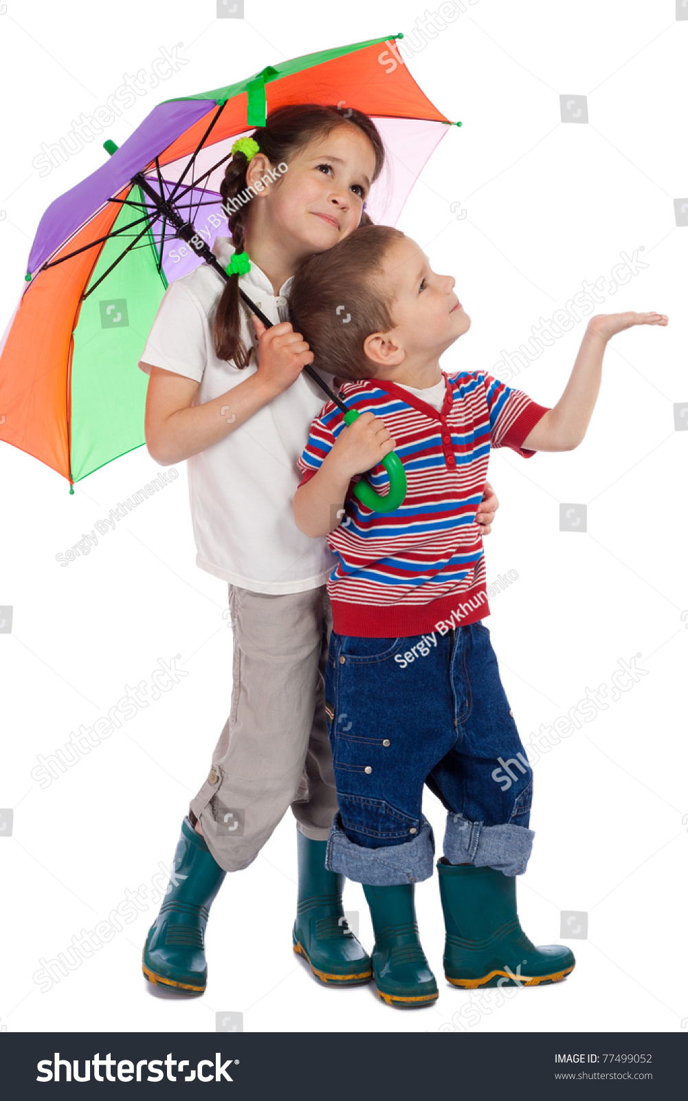 Two Little Children Holding Colored Umbrella And Looking Up Stock Photo ...