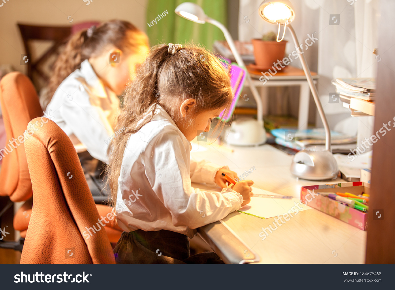 Two Little Girls Drawing Pictures Behind Stock Image Download Now