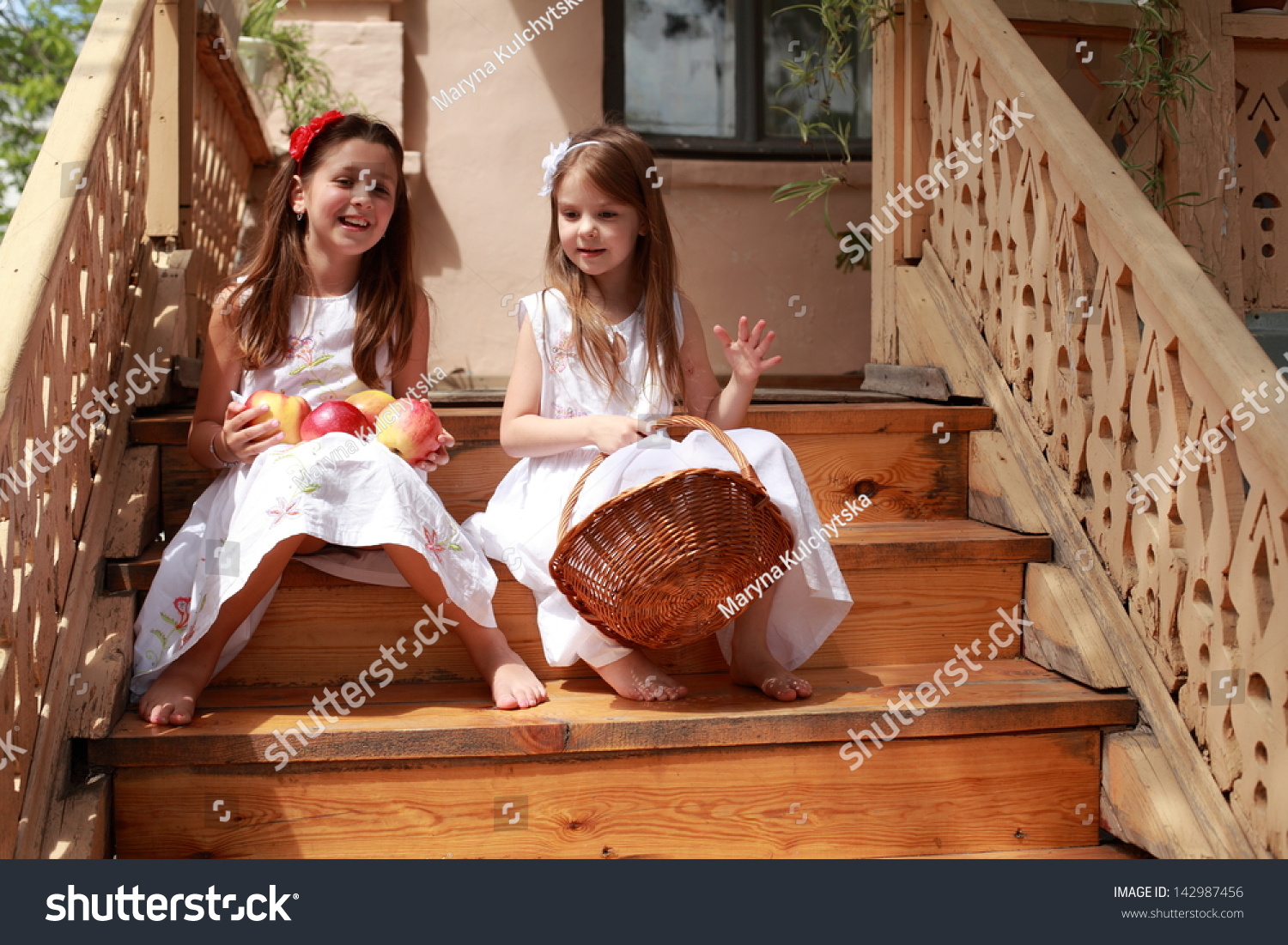 https://image.shutterstock.com/z/stock-photo-two-little-girls-in-white-dresses-and-bare-feet-holding-a-basket-of-apples-142987456.jpg