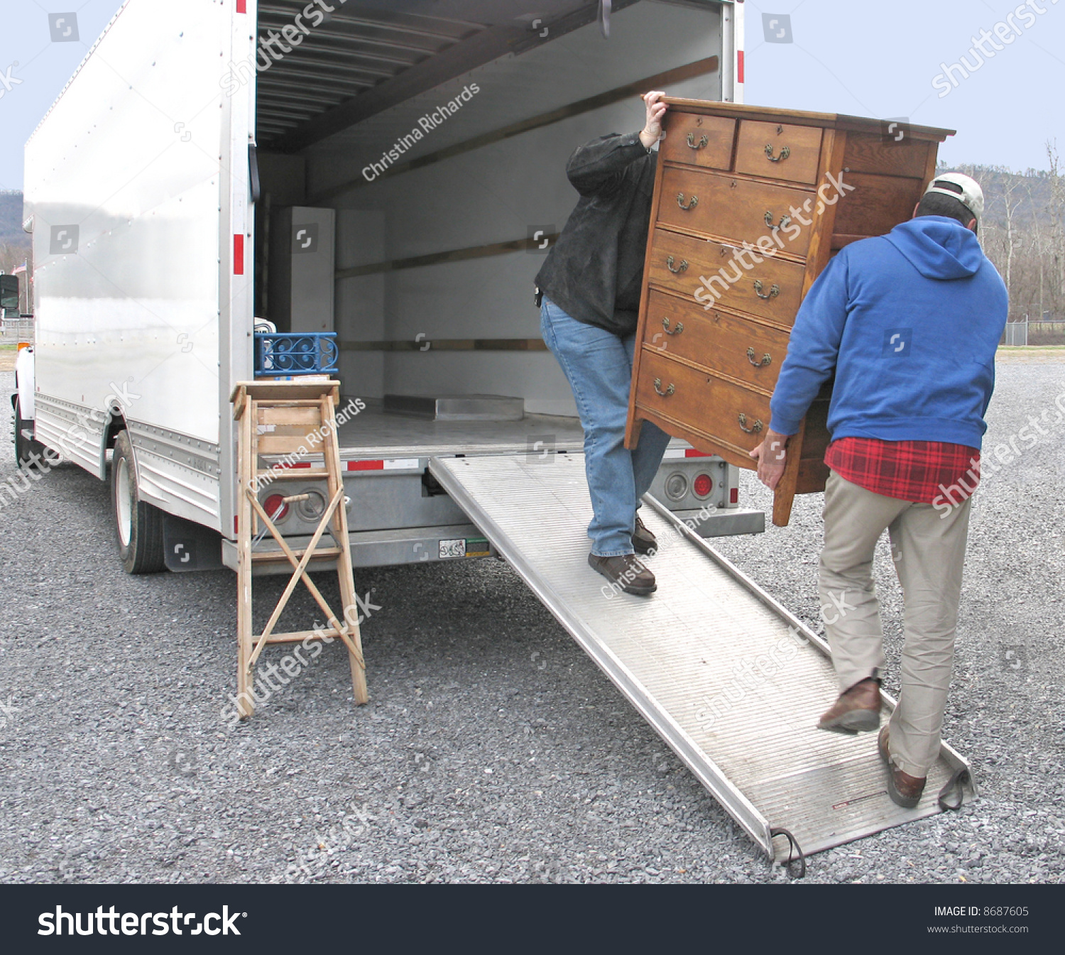 Two Men Carry Chest Drawers Onto Stock Photo Edit Now 8687605