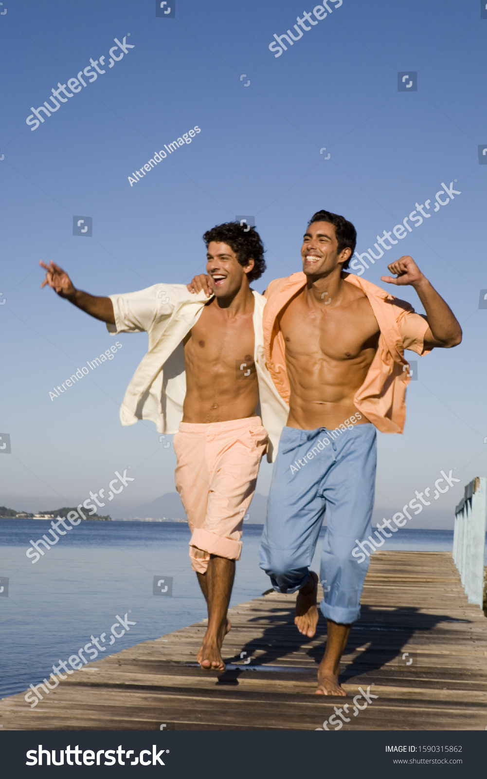 Two Men Walking Arm Arm On Stock Photo Edit Now