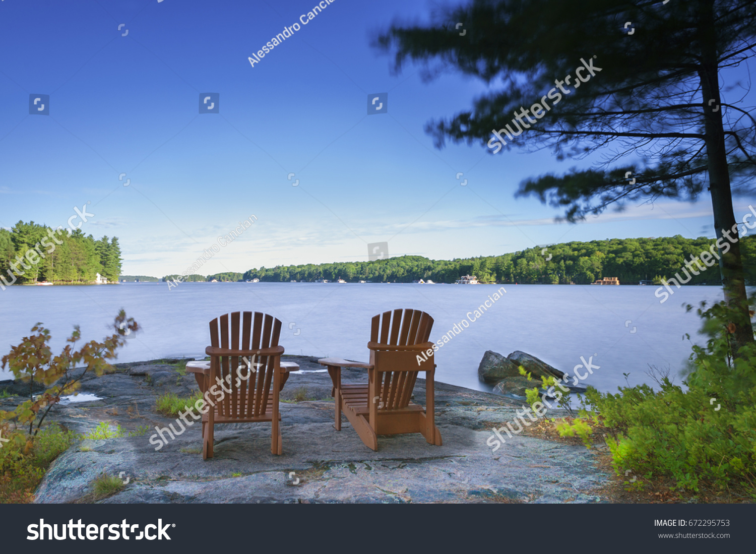 Two Muskoka Chairs Sitting On Rock Stock Photo Edit Now