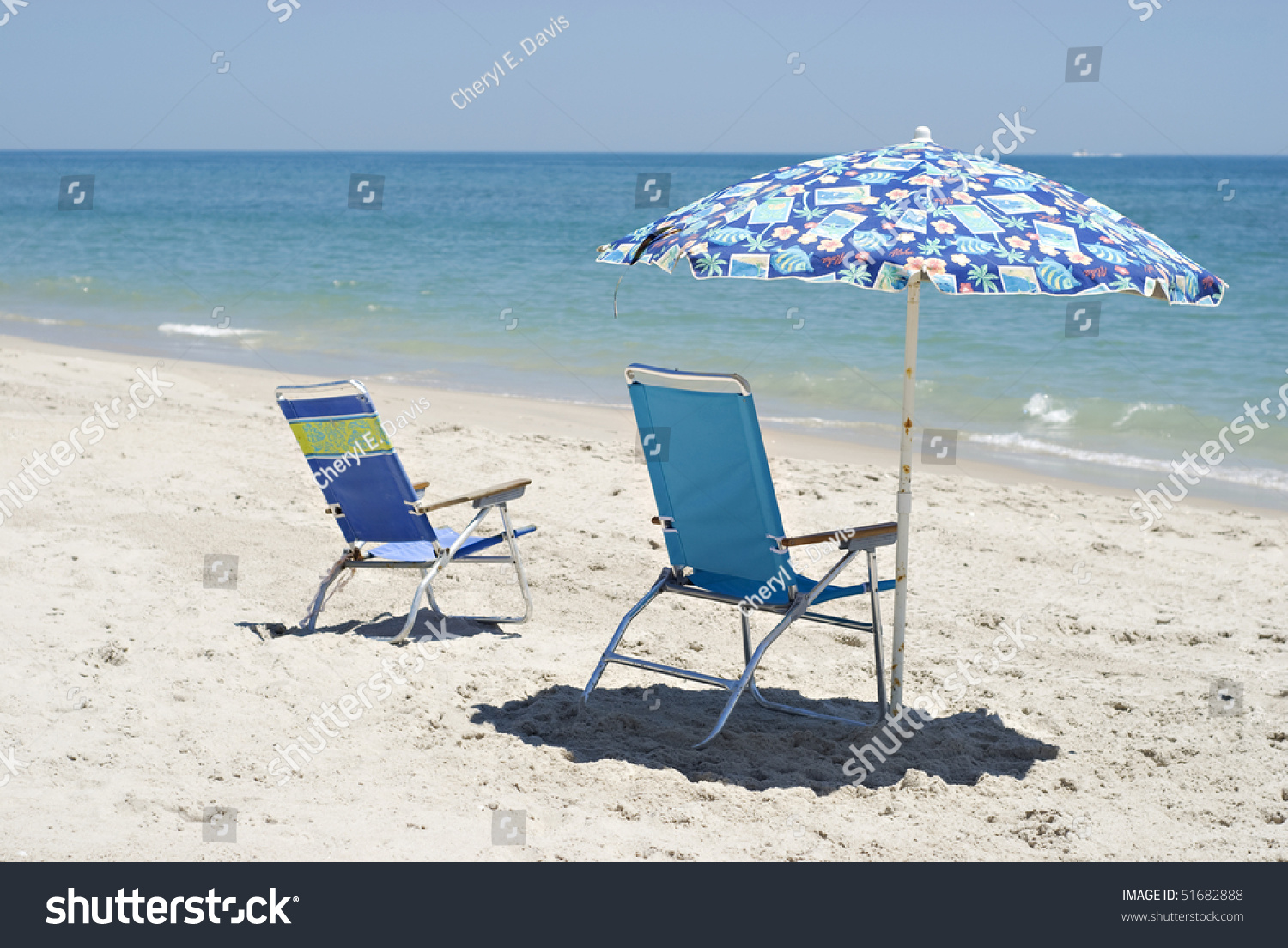 Two Old Beach Chairs And Umbrella On The Beach Facing The Beautiful ...