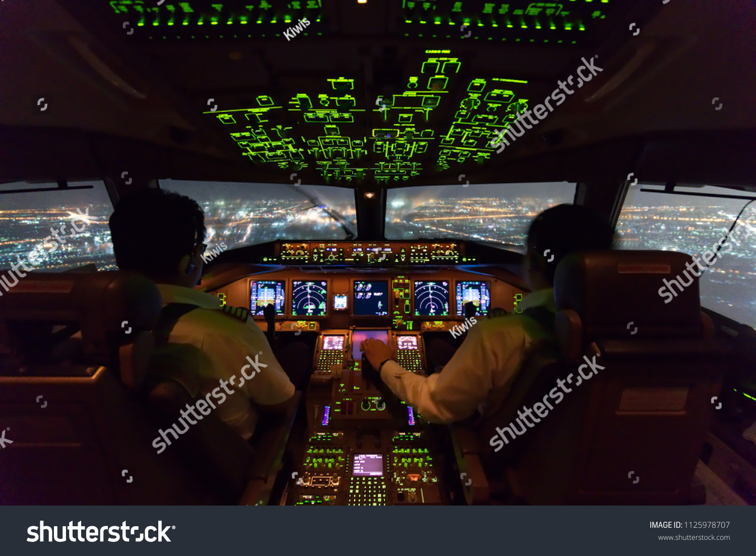 two-pilots-flying-airplane-approach-phase-stockfoto-1125978707