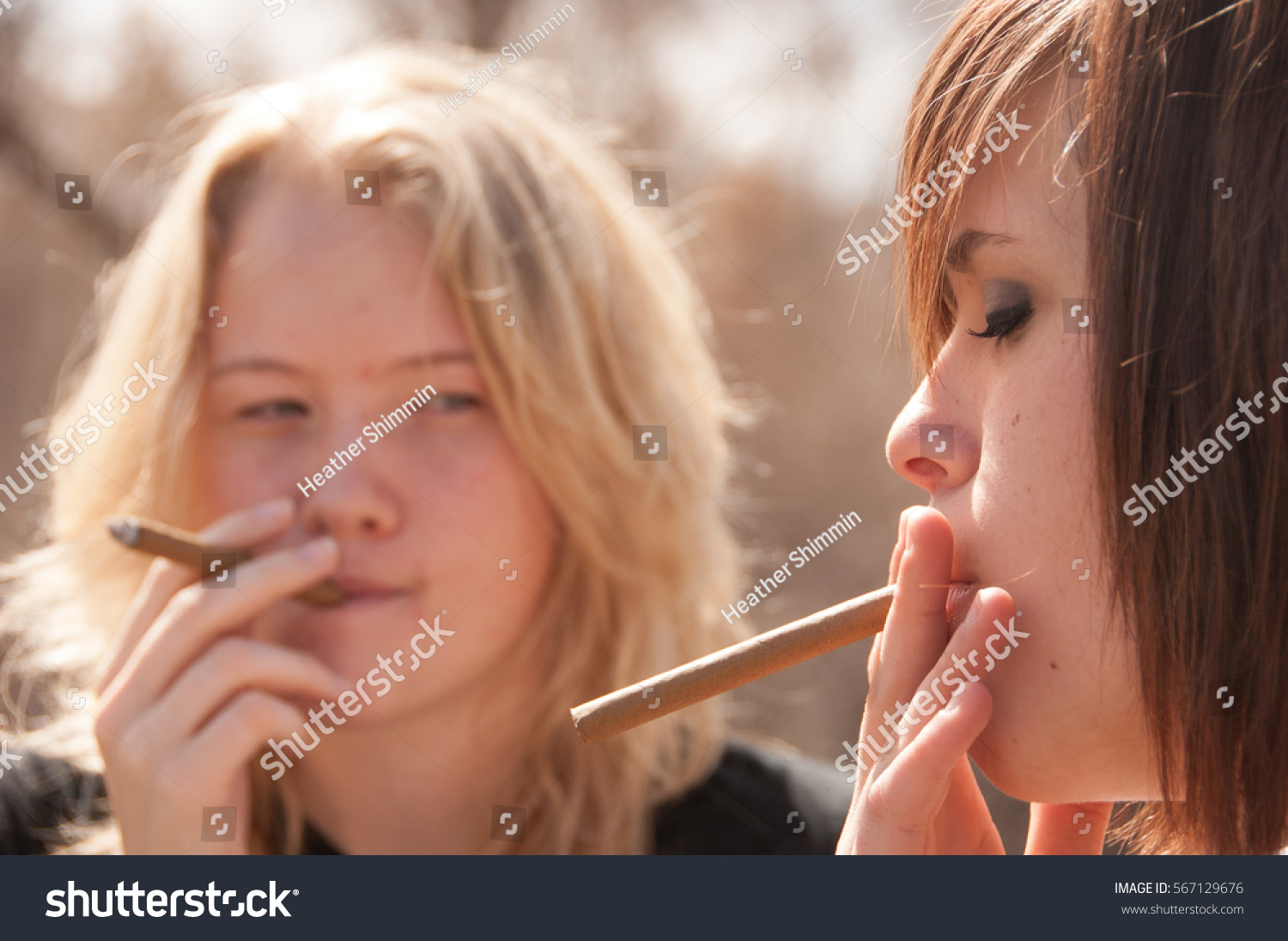 young teen girl smoking cigar