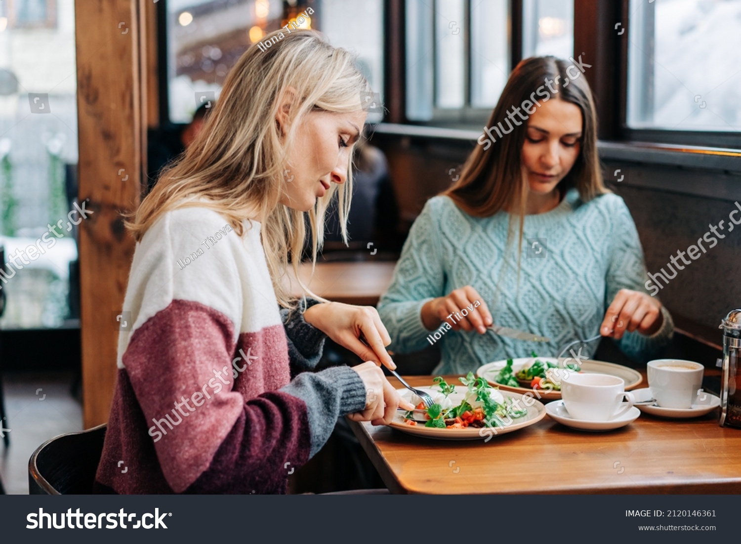 Two Women Eat European Cuisine Cozy Stock Photo (Edit Now) 2120146361