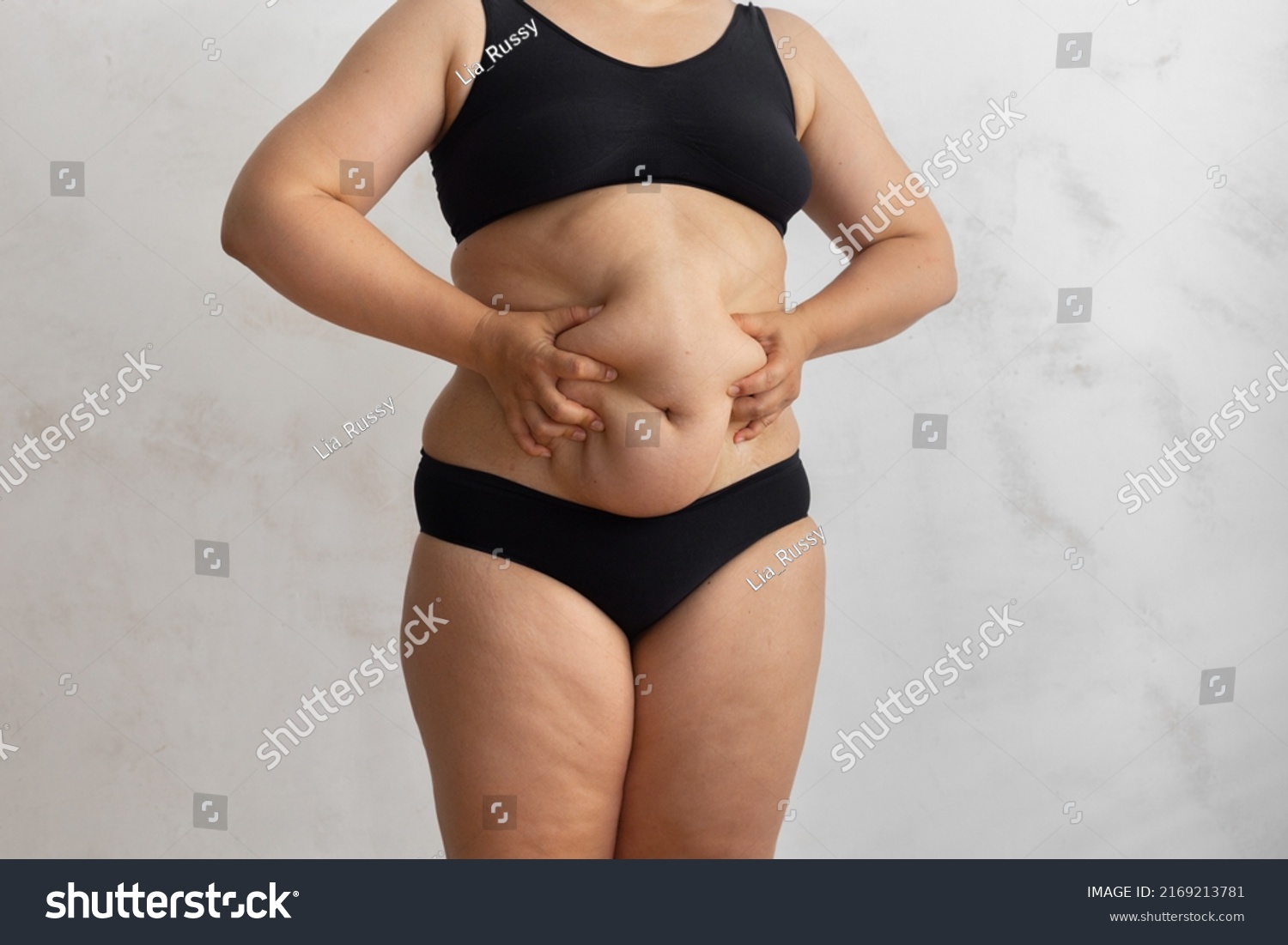 Stock Photo Unrecognizable Overweight Obese Woman In Black Bikini Touching And Squeezing Big Dangling Tummy 2169213781 