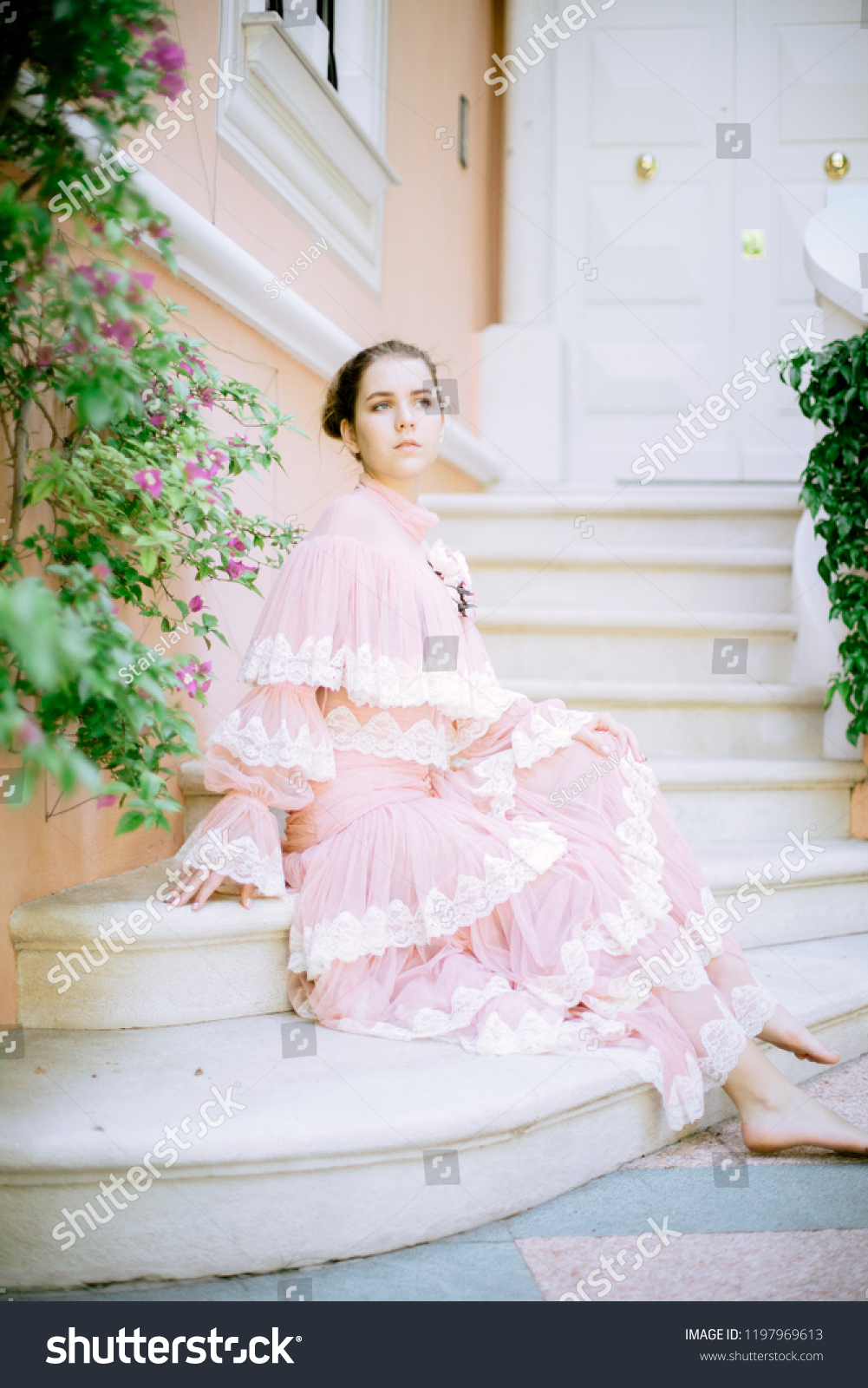https://image.shutterstock.com/z/stock-photo-very-beautiful-young-girl-with-blond-hair-with-a-nominal-transparent-pink-dress-on-the-background-1197969613.jpg