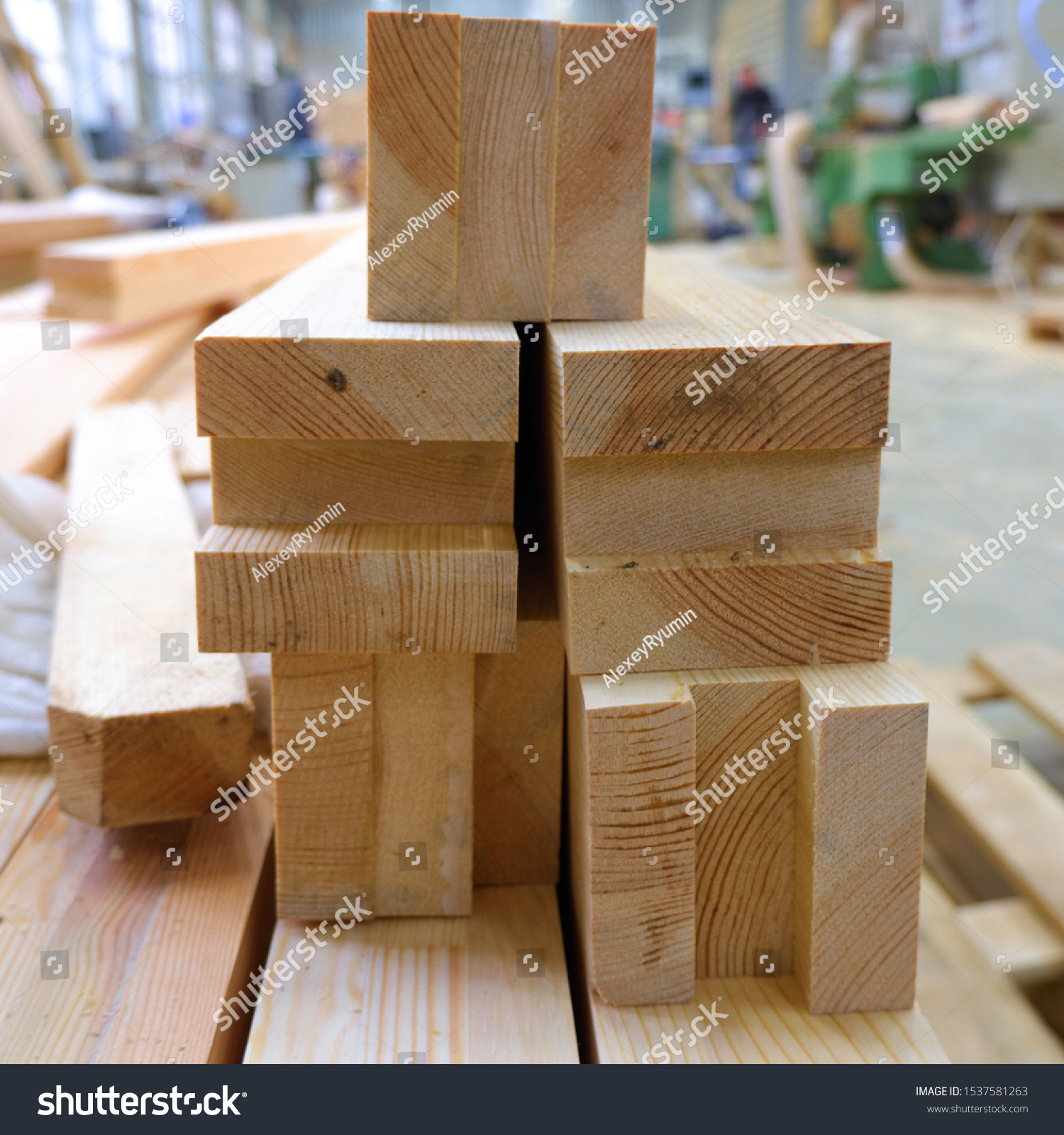 View from butt of stack of three-layer wooden glued laminated timber beams from pine finger joint spliced boards for wooden windows